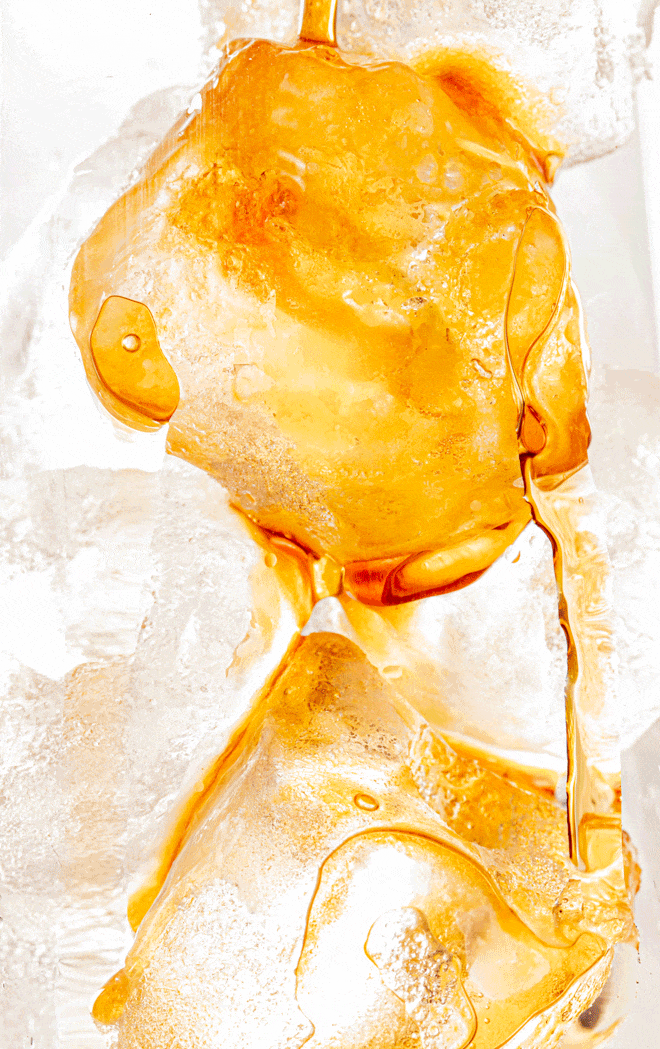 Close-up of golden amber cannabis concentrate wax with a glossy, translucent texture