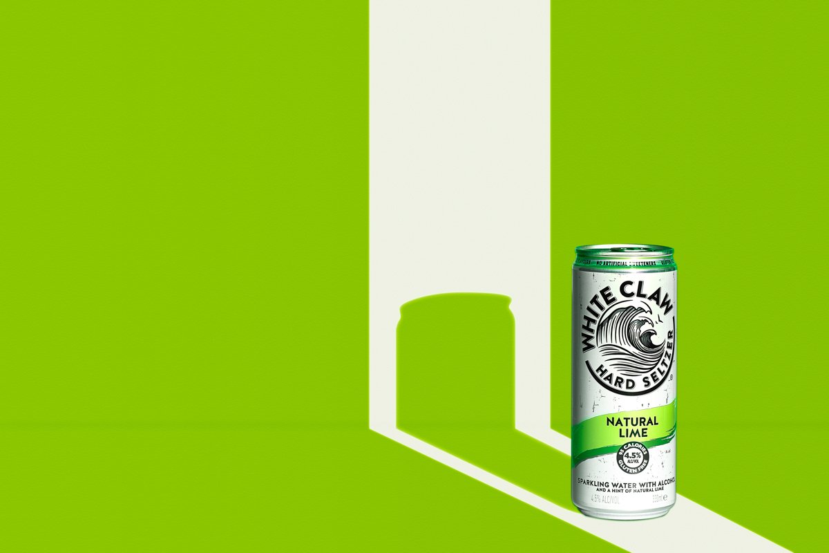White Claw Hard Seltzer Natural Lime can, 4.5% ALC/VOL, on a green background