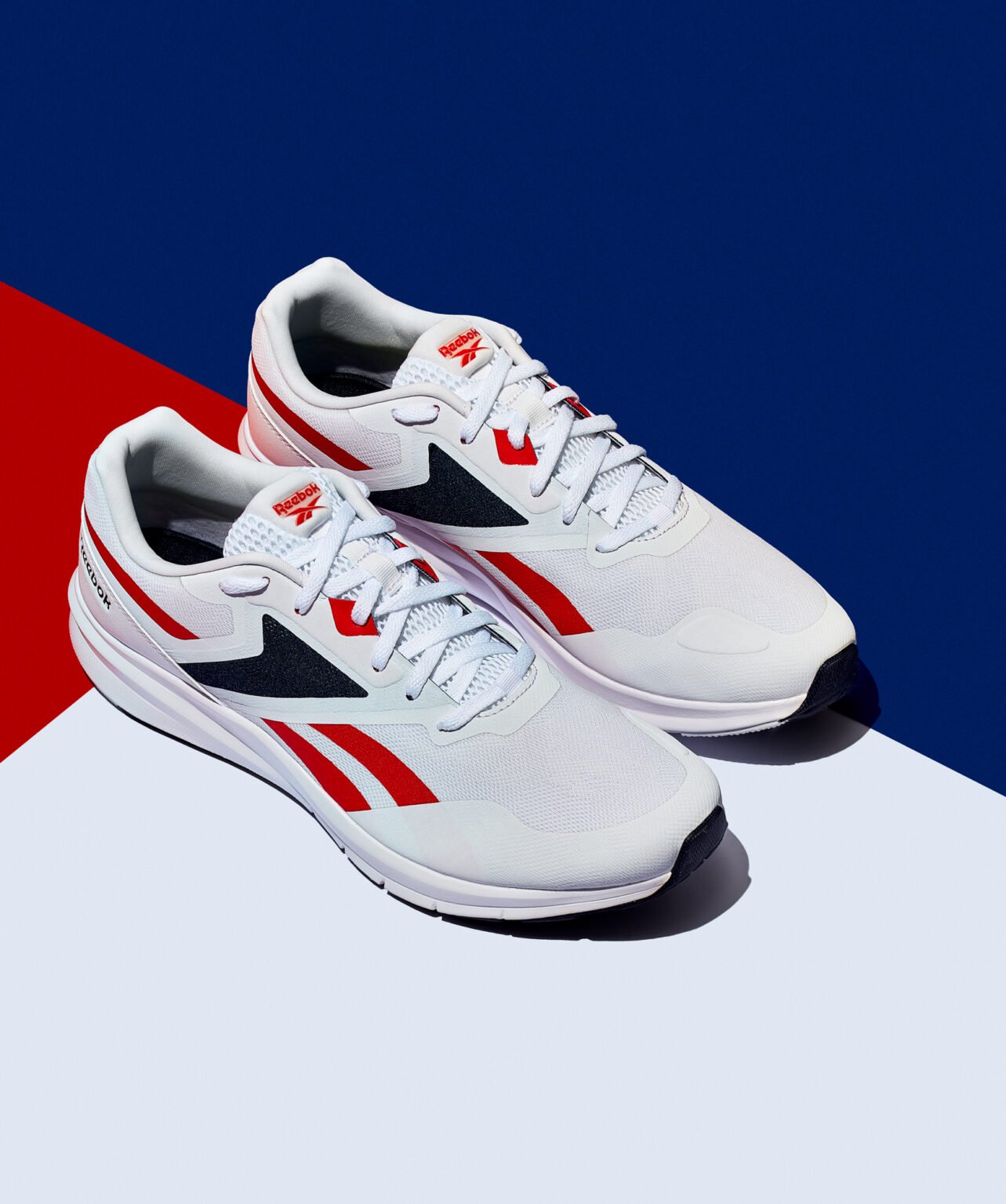 Pair of Reebok running trainers in white with red and navy accents