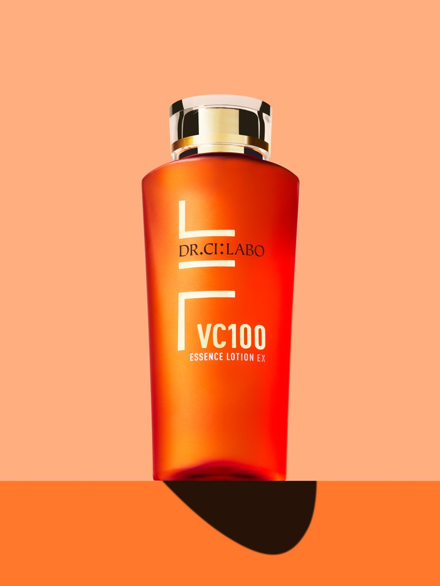 Bottle of Dr.Ci:Labo VC100 Essence Lotion EX with a gold-capped orange design