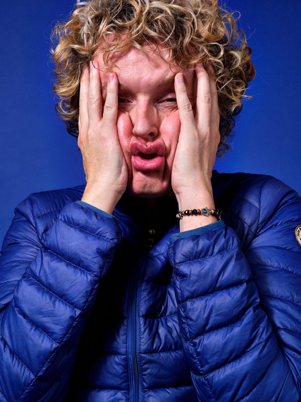 An man scrunching his face in a studio photograph taken by commercial London photographer Scott Choucino