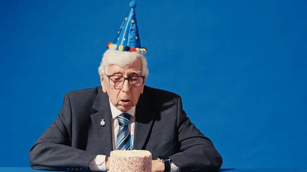 Old man blowing out candles