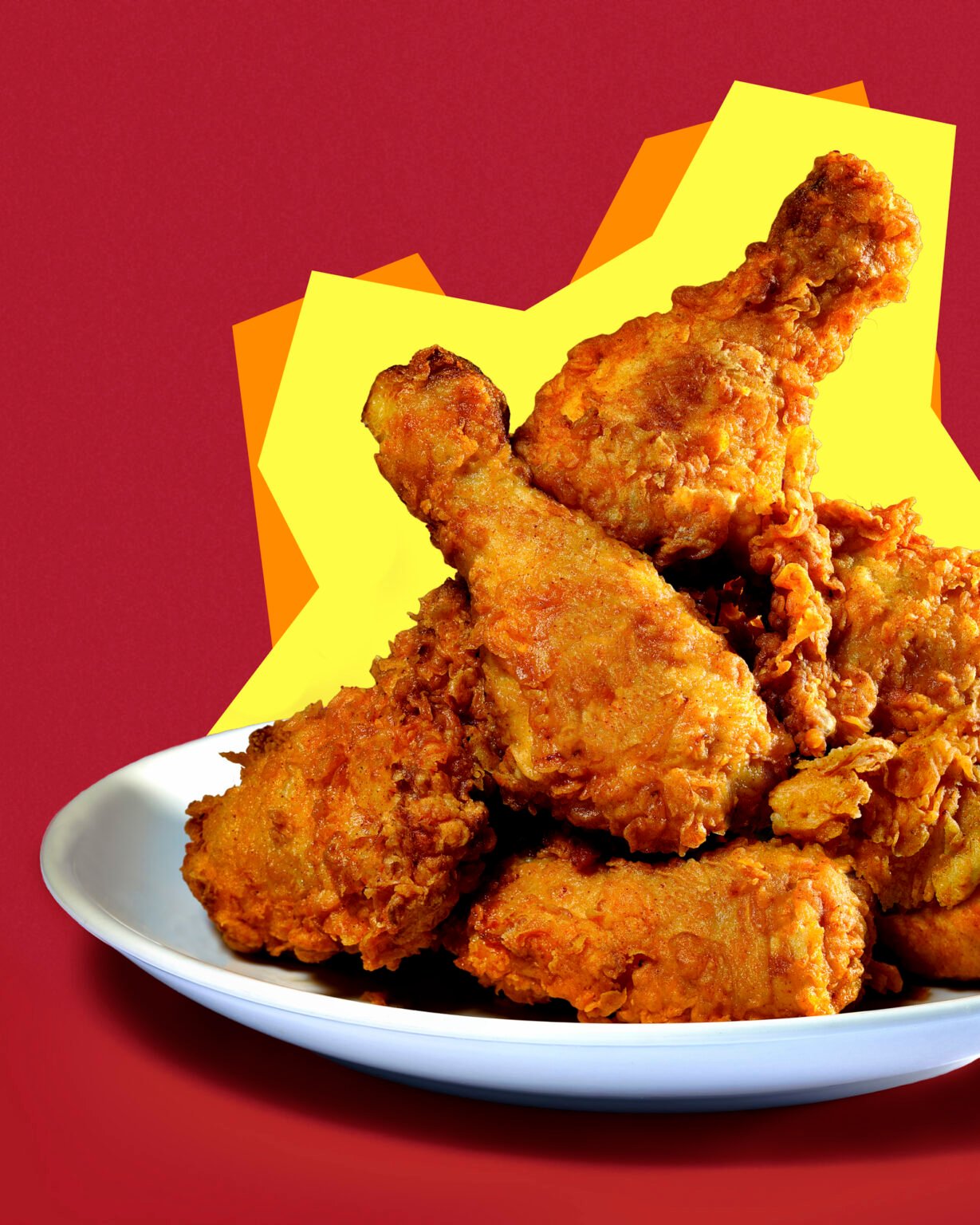 commercial food photograph of a plate of fried chicken on a bold and graphic background