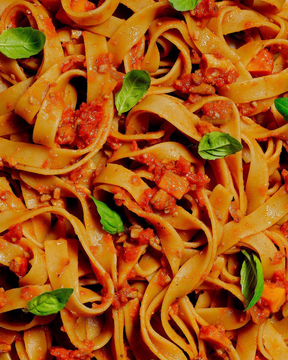 full screen macro photograph of italian made pasta with herbs